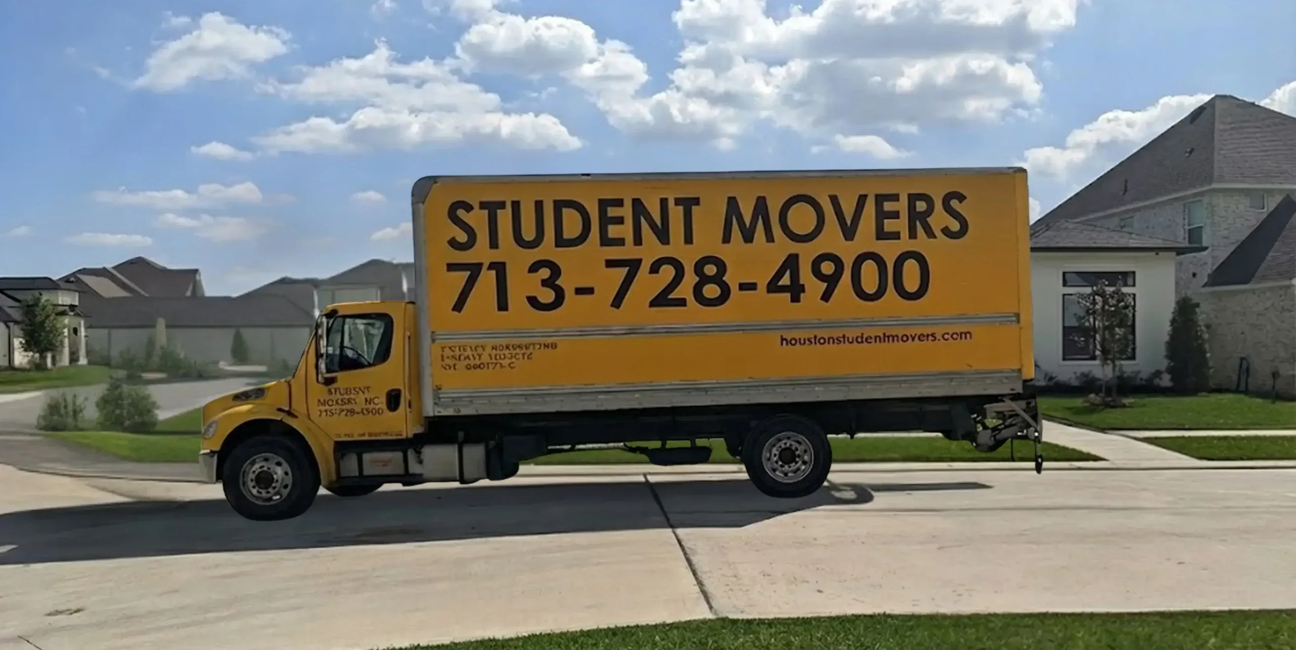Side view of a Student Movers Inc truck showing the 713-728-4900 contact number.